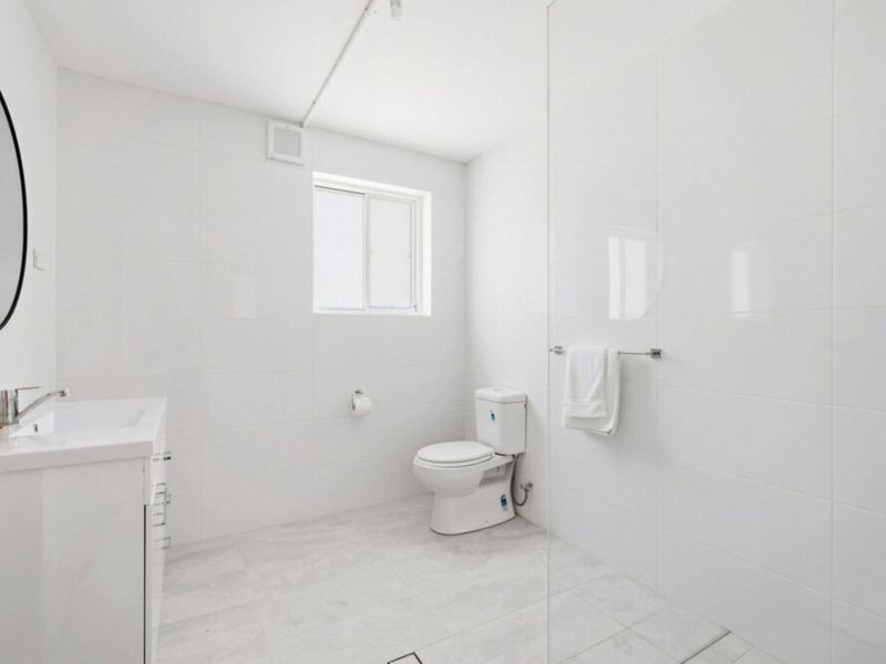 Modern bathroom with walk-in shower and vanity.