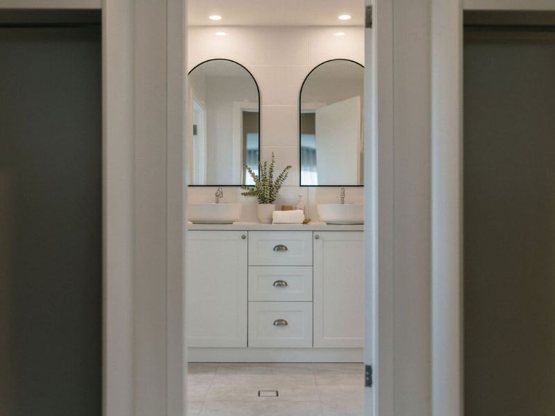 Stylish ensuite featuring a double vanity and modern finishes.