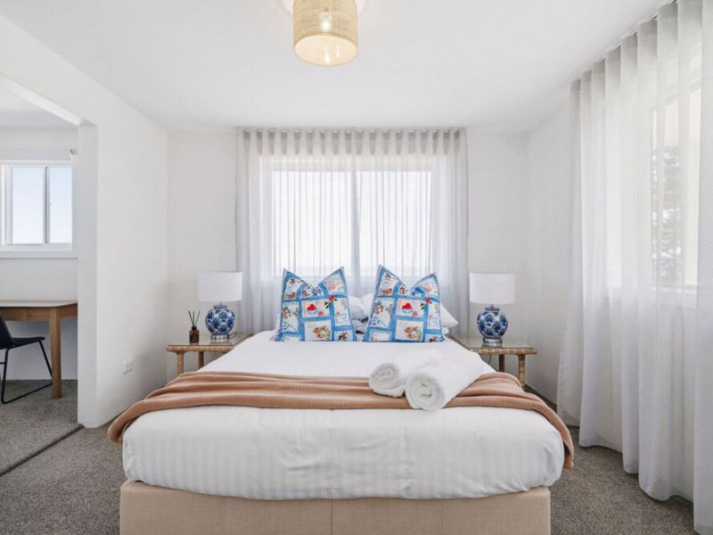 Relaxing bedroom with plush bedding and airy interiors.