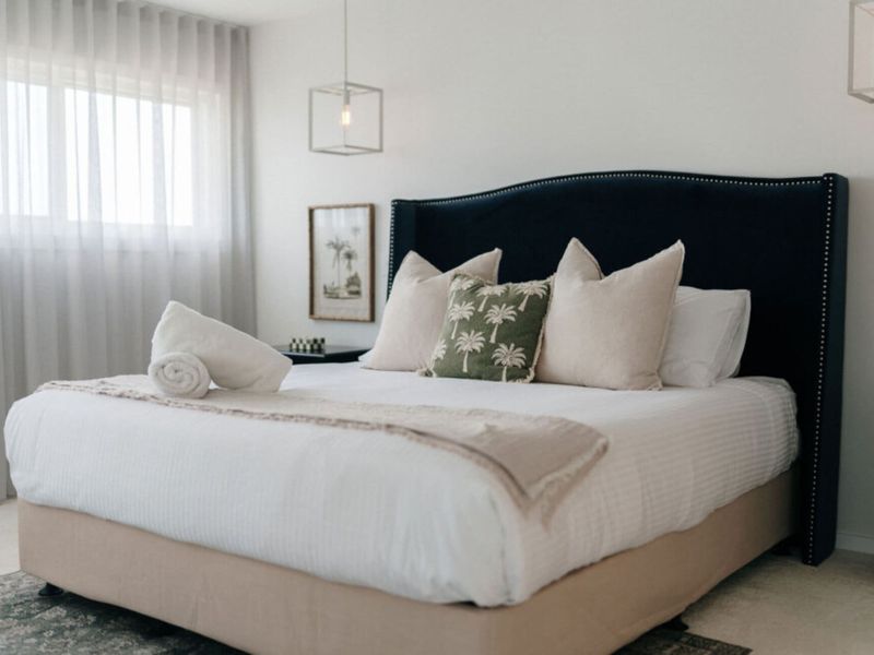 Spacious king bedroom with premium linens and elegant styling.