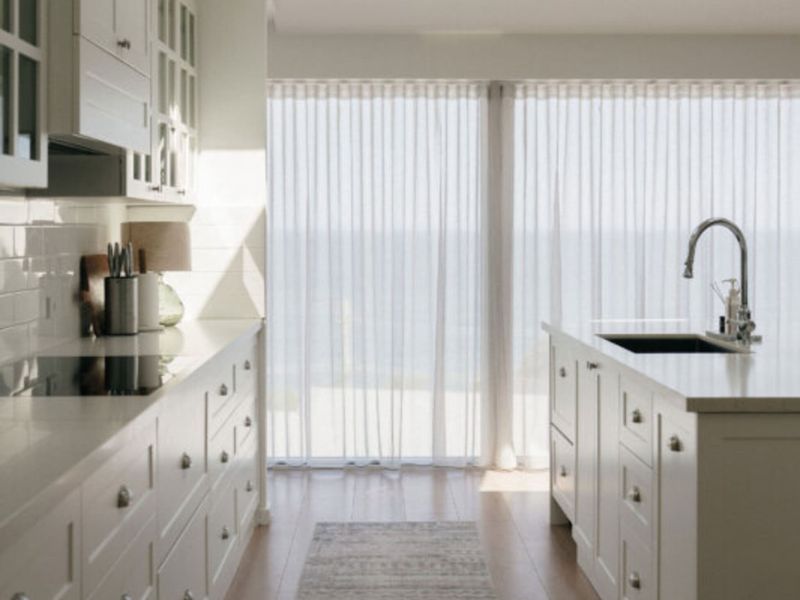 Spacious kitchen with large windows and abundant natural light.