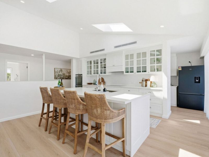 Open-plan kitchen with breakfast bar and ample workspace.