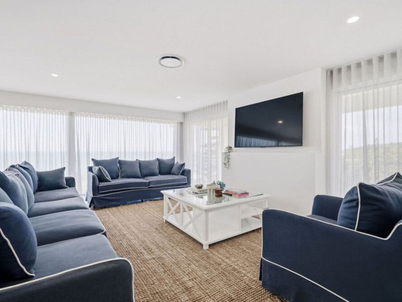 Spacious lounge with comfortable seating and Smart TV.