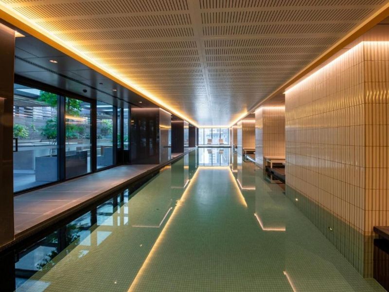 Luxurious lap pool with sleek lighting and tranquil ambiance.
