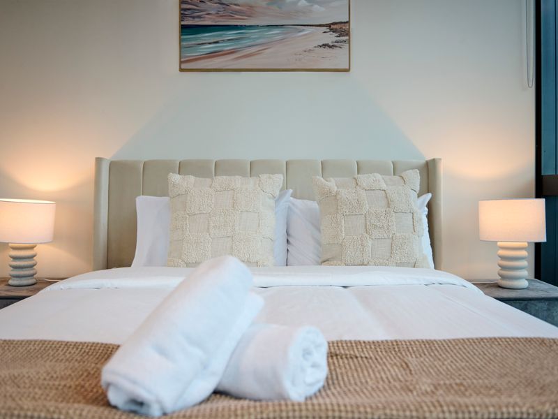 Luxurious master bedroom with soft lighting and hotel-style comfort.