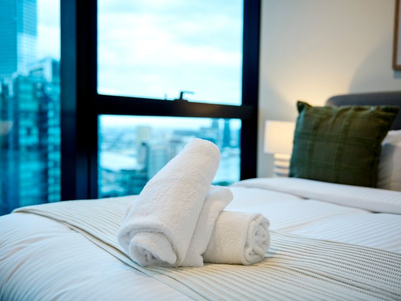 Wake up to stunning skyline vistas from this serene bedroom escape.