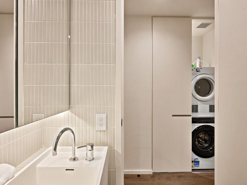 Modern vanity and laundry space designed for everyday convenience.
