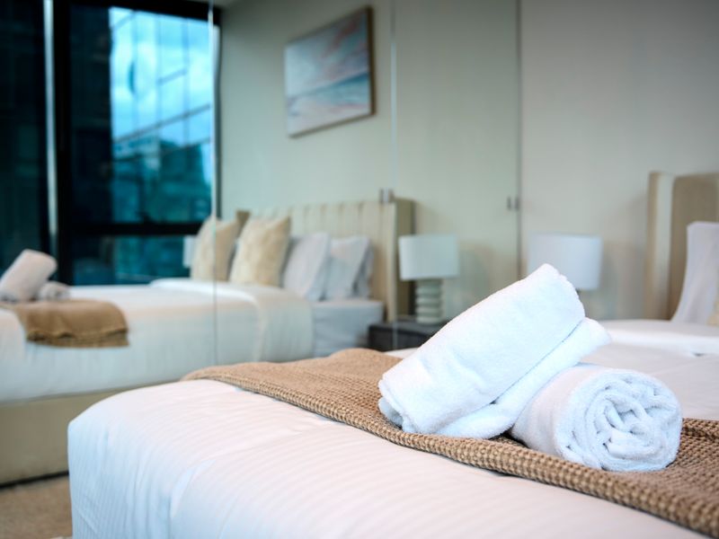 Plush bedding and mirrored finishes create a relaxing retreat.