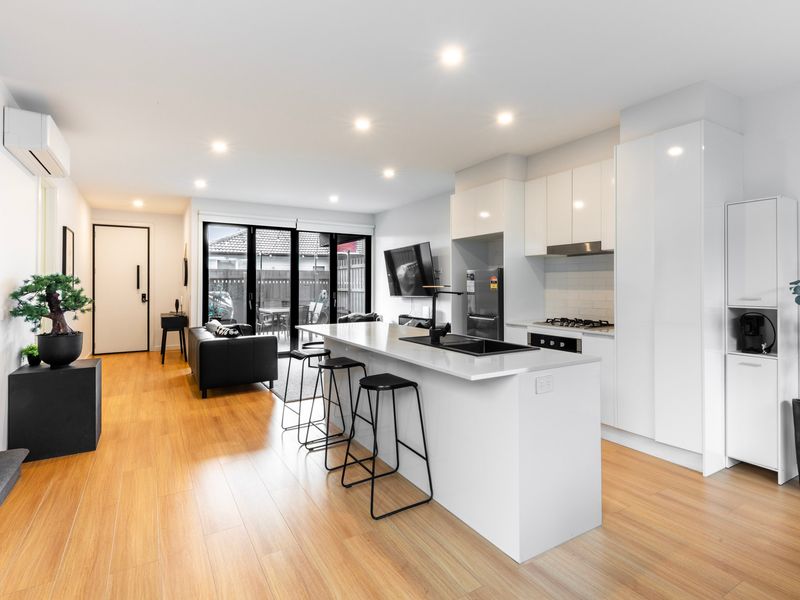 Cook, dine, and unwind in a modern open-plan kitchen and living space.