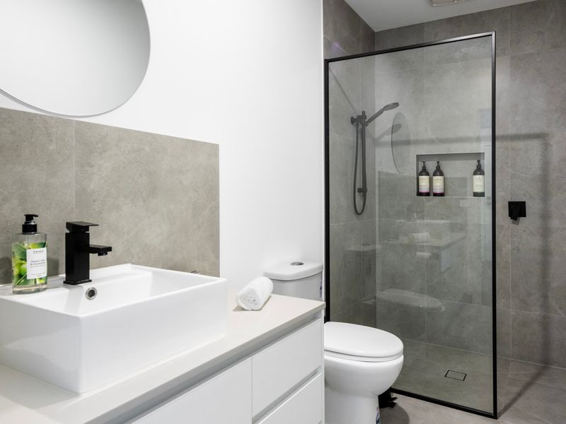 Freshen up in the sleek, modern bathroom featuring quality finishes and a spacious shower.