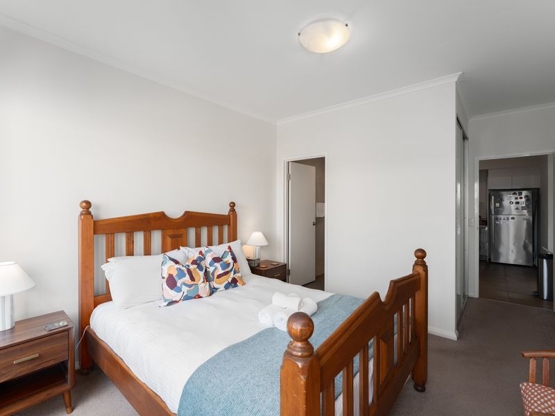 This bedroom features a walk-in shower and quality finishes for everyday comfort.