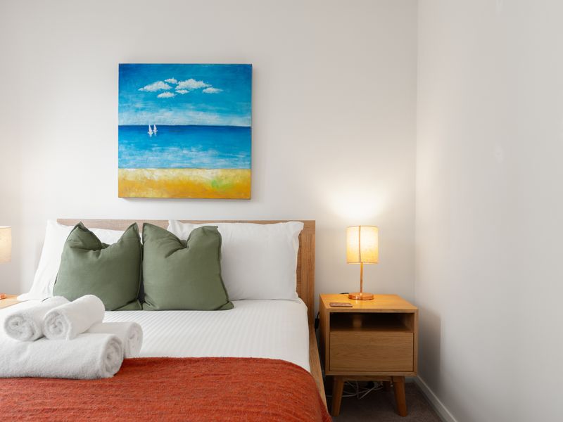 Sink into a restful night's sleep in the bright and beautifully styled master bedroom.