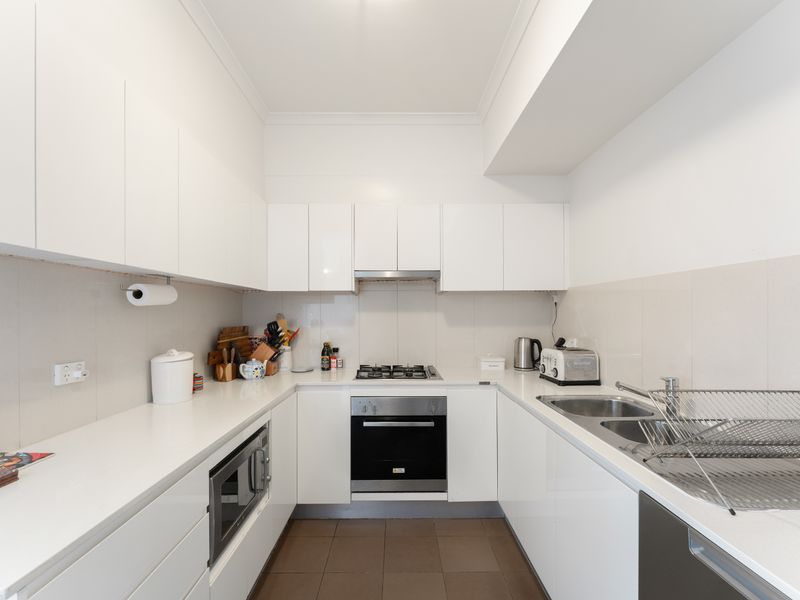 Cook with ease in the fully equipped kitchen featuring modern appliances and generous bench space.
