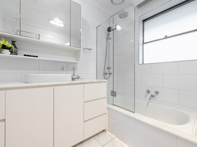 The modern bathroom features a full-size bathtub for a relaxing soak.