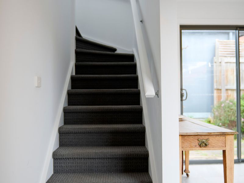 The staircase leads to additional living spaces while enhancing the home's unique layout.