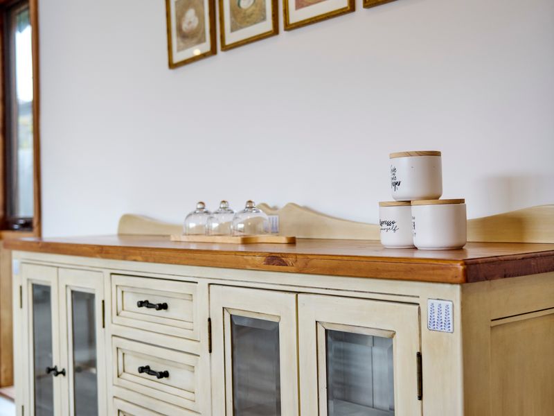 A beautiful timber buffet adds both functionality and character to the dining space.