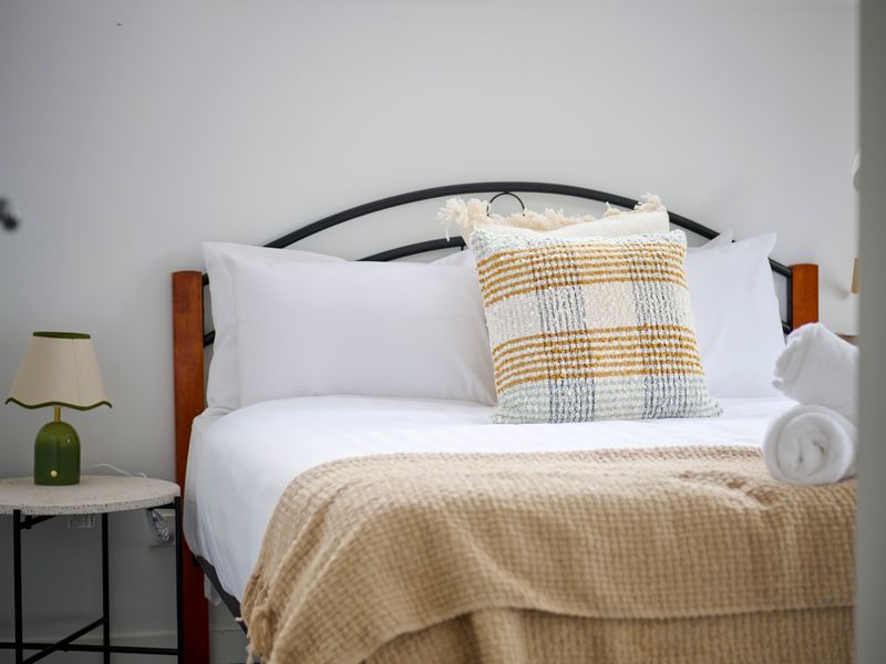 Warm lighting and comfortable furnishings create a peaceful bedroom retreat.