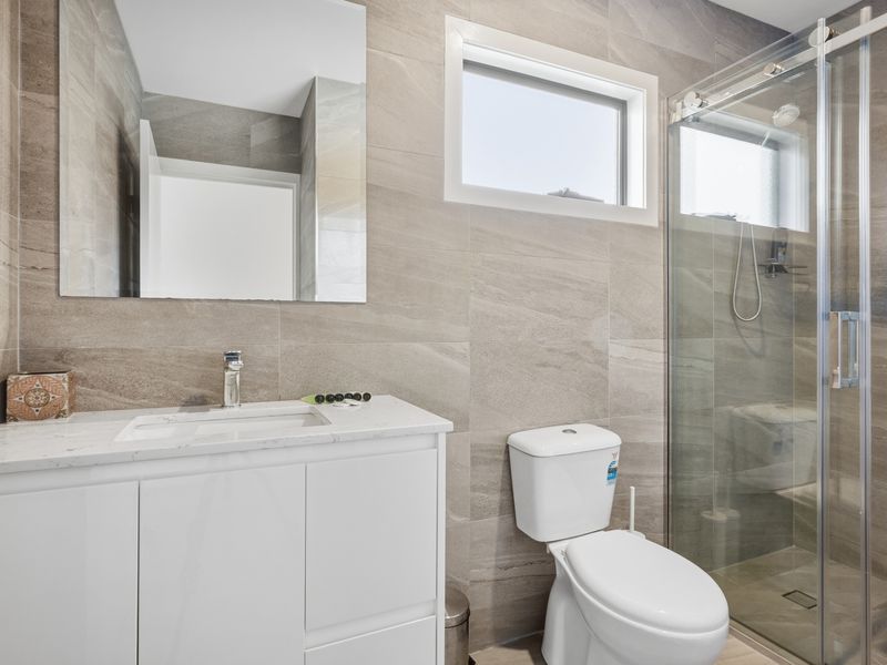 The modern bathroom combines sleek finishes with practical functionality.