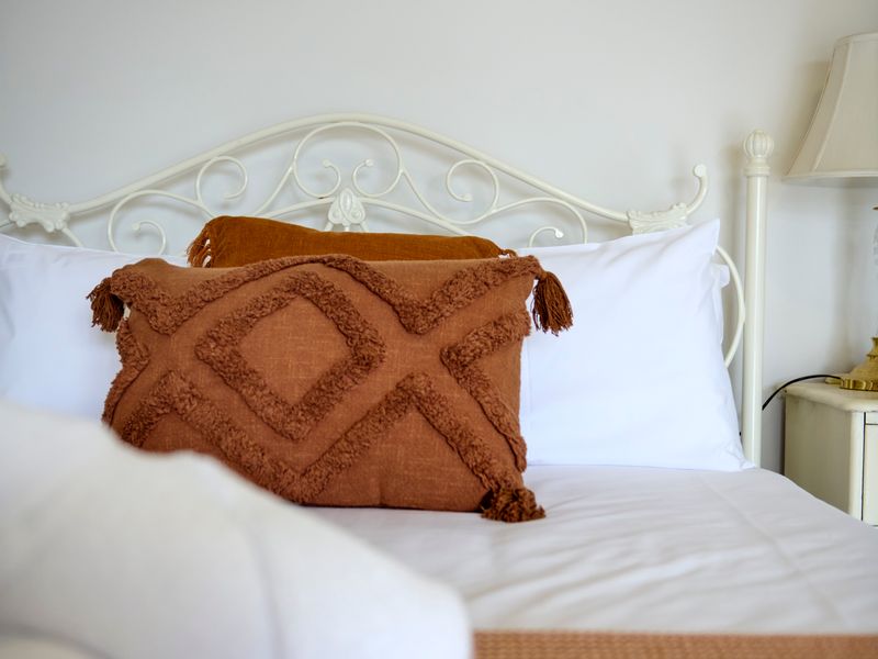 Thoughtfully curated furnishings create a cosy and inviting bedroom atmosphere.