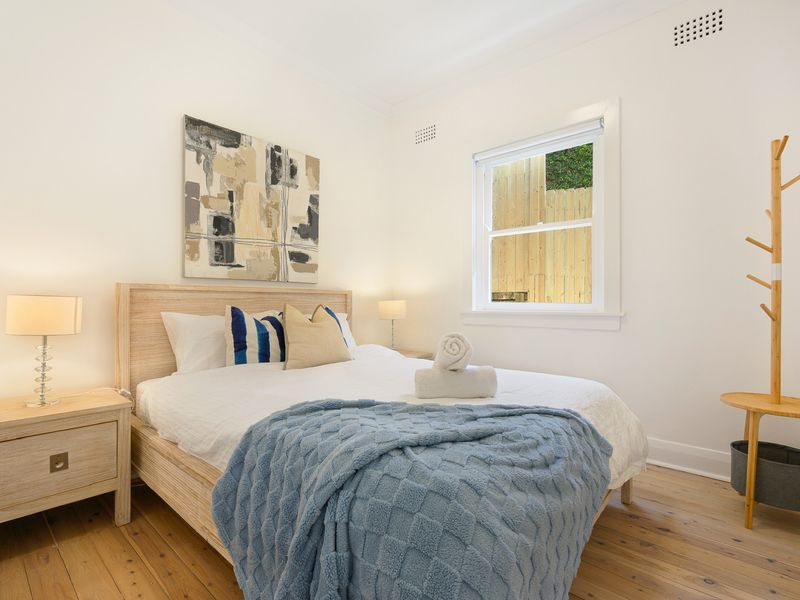 Peaceful bedroom featuring quality linen and plenty of natural light.