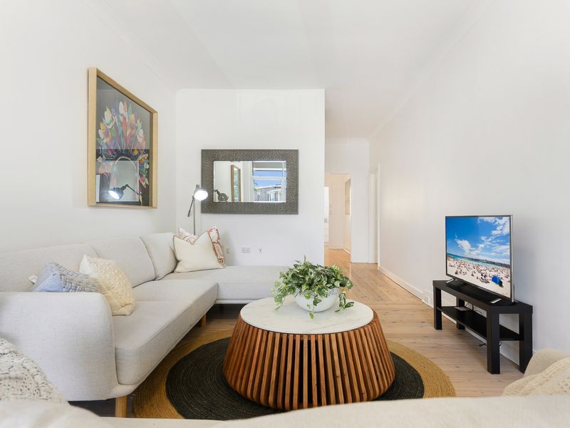 Comfortable living area with Smart TV and stylish coastal décor.
