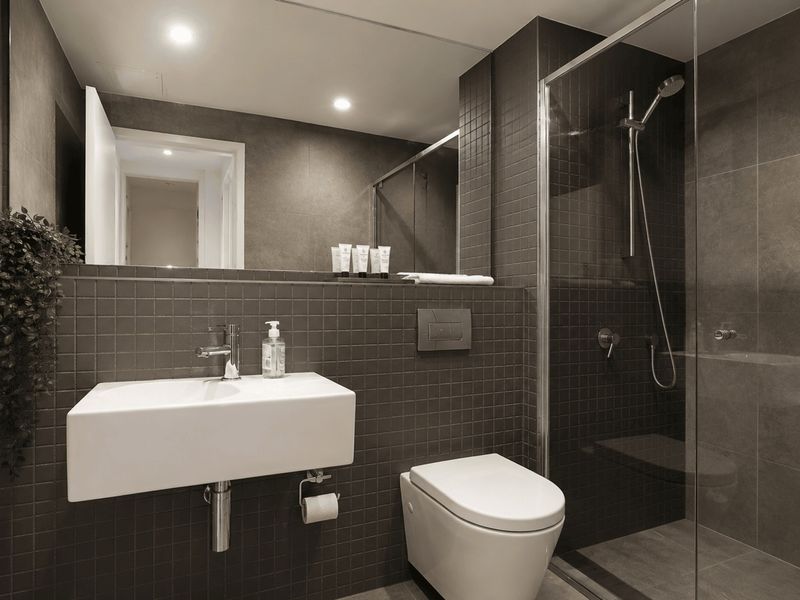 Stylish ensuite featuring a walk-in shower and modern vanity.