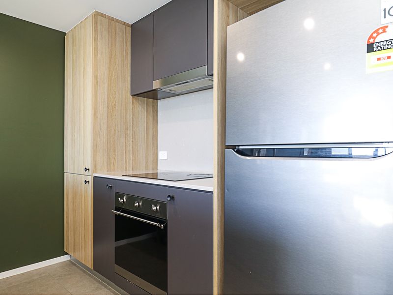 Full-size fridge, built-in oven, and ample kitchen storage.
