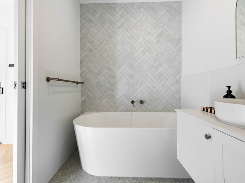 A spacious bathroom with a sleek vanity provides comfort and convenience throughout your stay.