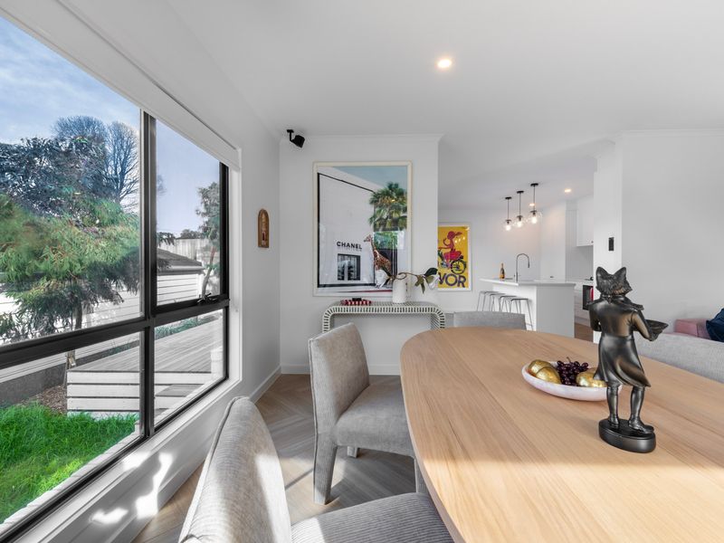 The open-plan layout flows seamlessly from the dining area to the stylish kitchen.