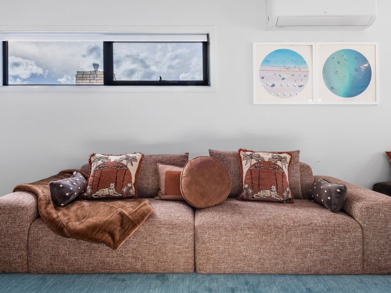 Sink into the plush sofa and enjoy movie nights in this cosy entertainment space.