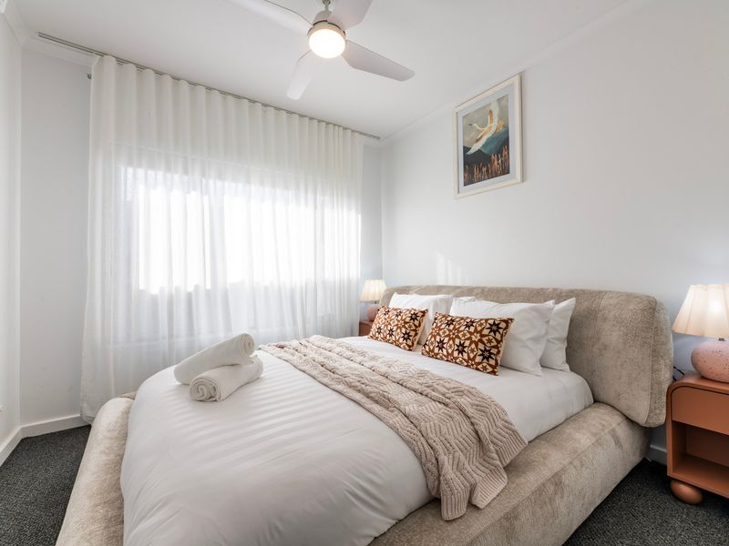 A cosy guest bedroom provides everything needed for a relaxing stay.