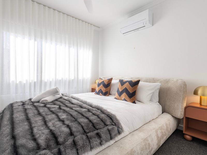 Enjoy a restful night's sleep in this bright and tranquil bedroom with soft natural light.