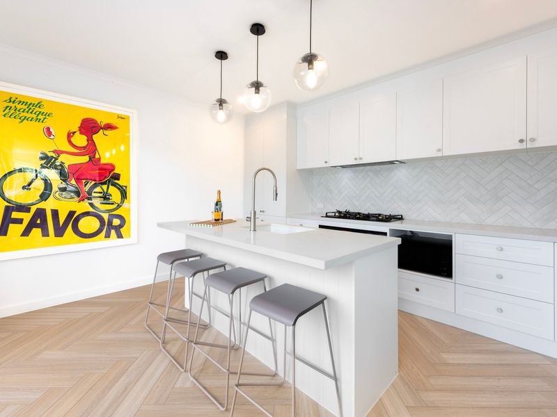 Cook your favourite meals in the sleek, modern kitchen featuring quality appliances and ample bench space.