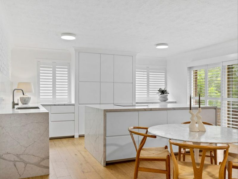 The stylish kitchen is fully equipped with quality appliances, ample storage, and generous bench space.