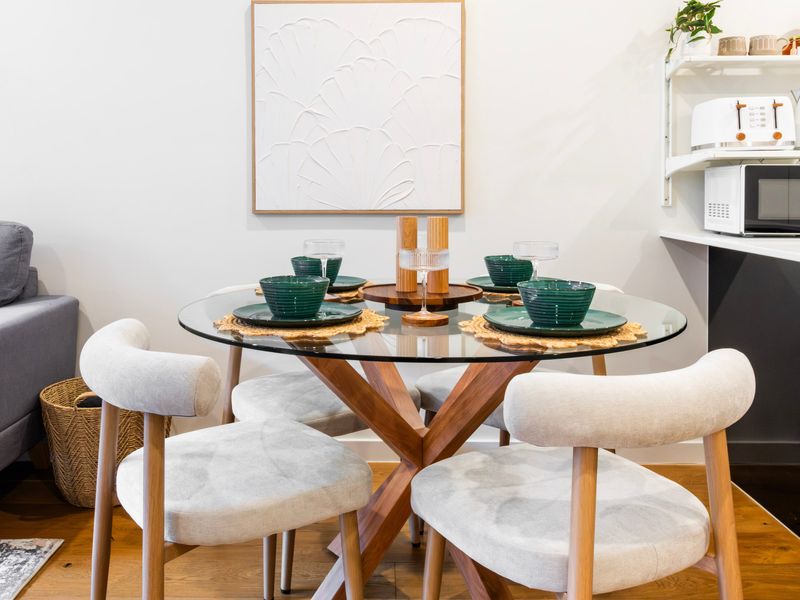 Gather around the dining table for intimate meals in a stylish setting.