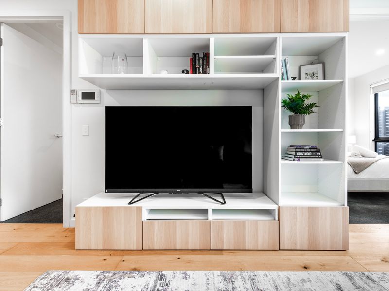 Custom built shelving creates an elegant entertainment space with generous storage.