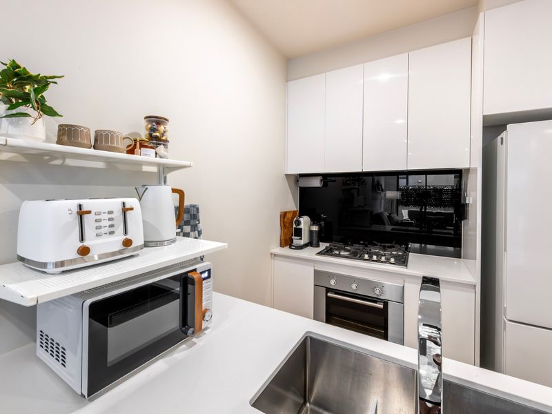 The fully equipped kitchen offers modern appliances and ample space for cooking.