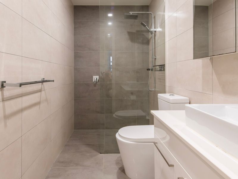 Refresh in the modern bathroom featuring a walk-in shower and quality finishes.