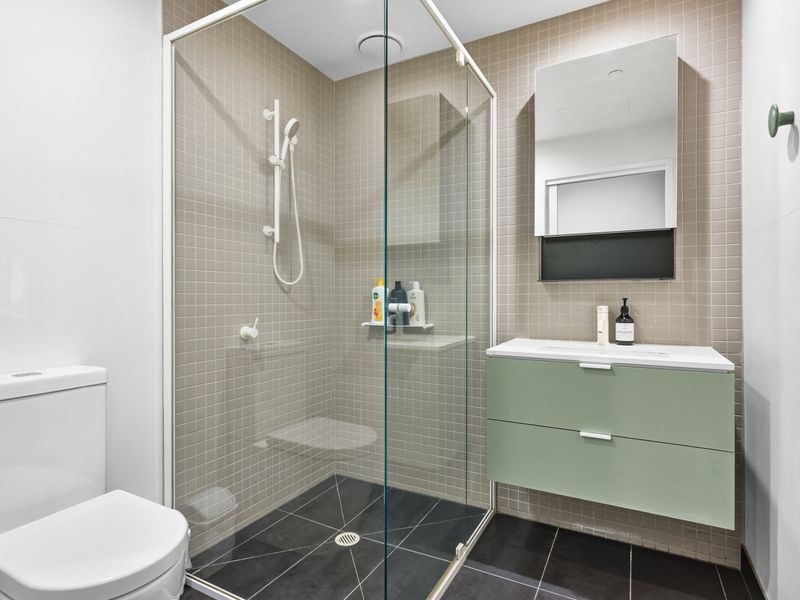 The stylish bathroom features a spacious walk-in shower and contemporary finishes.
