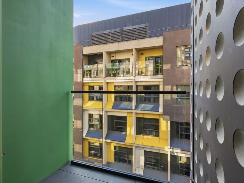 The private balcony offers an inviting spot to enjoy the fresh air and urban outlook.