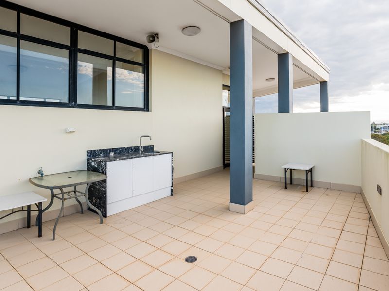 Large covered terrace with outdoor kitchenette and dining area.