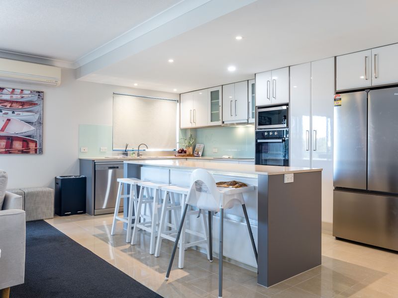Spacious kitchen featuring a breakfast bar and quality appliances.