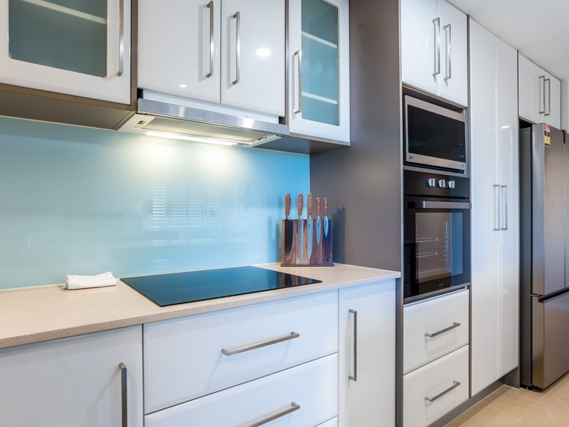 Modern kitchen with generous storage and built-in appliances.