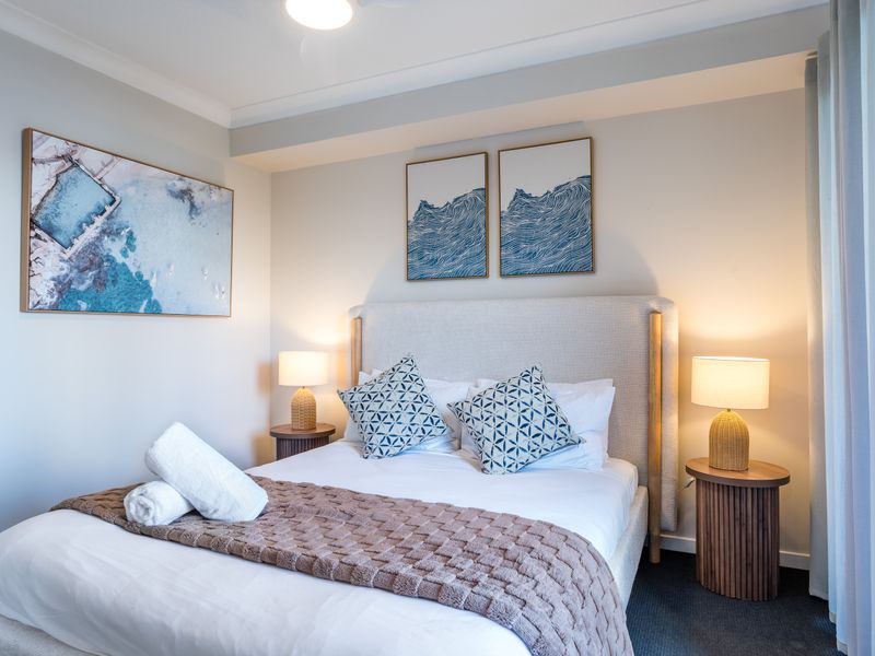 Comfortable bedroom with a plush queen bed and balcony access.