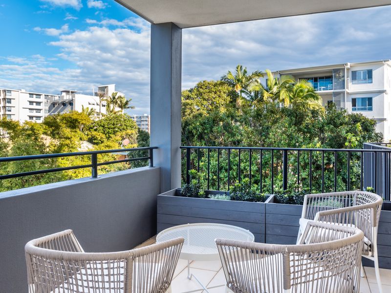 Private balcony with outdoor seating overlooking the neighbourhood.