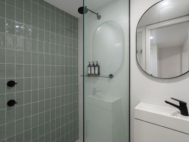 The stylish bathroom showcases contemporary finishes and a spacious shower.