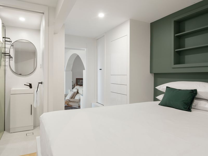 Wake up refreshed in a calming bedroom with smart storage solutions.