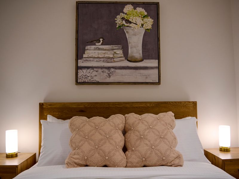 Elegant styling and quality linens add comfort to the bedroom.