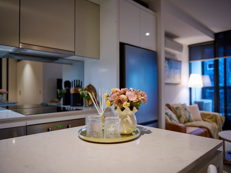 Fresh flowers and stylish finishes complete the sophisticated kitchen space.
