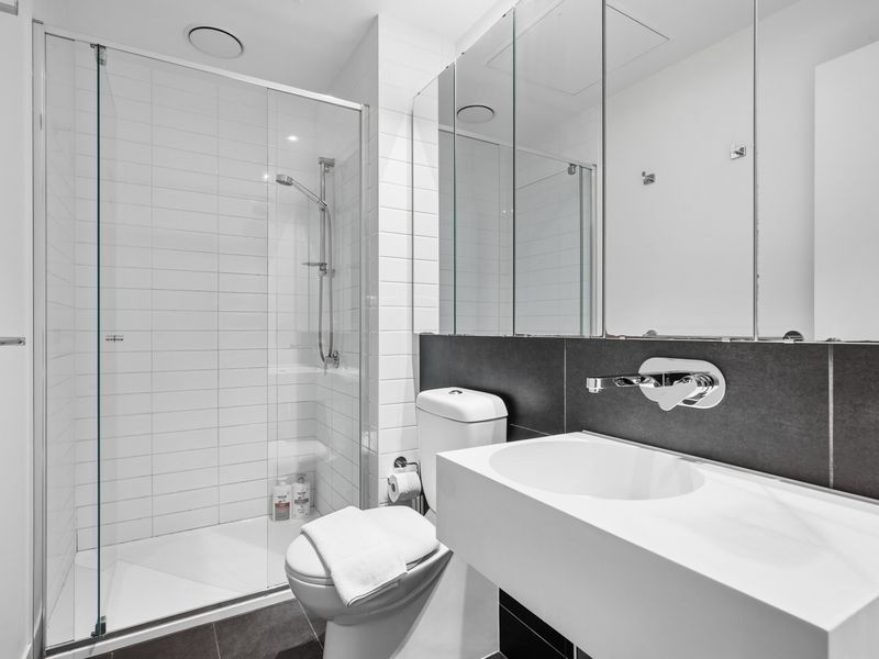 Refresh in the spacious bathroom with a walk-in shower and sleek vanity.